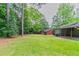 Large, grassy backyard with mature trees and partial fencing at 332 Cheryl Ct, Jonesboro, GA 30238
