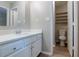 Bright bathroom featuring a white vanity, a toilet, and built-in shelves, offering functionality at 332 Cheryl Ct, Jonesboro, GA 30238