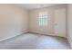 Comfortable bedroom features soft gray carpet, a window with blinds, and neutral walls at 332 Cheryl Ct, Jonesboro, GA 30238