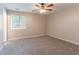 Bright bedroom with neutral walls, soft gray carpet, and a ceiling fan, offering a calming atmosphere at 332 Cheryl Ct, Jonesboro, GA 30238