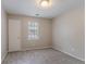 Neutral bedroom featuring a window with blinds and soft gray carpet, offering a serene retreat at 332 Cheryl Ct, Jonesboro, GA 30238