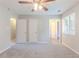 Bright bedroom with soft gray carpet, a ceiling fan, and a window, offering a relaxing retreat at 332 Cheryl Ct, Jonesboro, GA 30238
