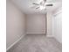 Bright bedroom with gray carpet and a ceiling fan offers neutral tones and a comfortable living space at 332 Cheryl Ct, Jonesboro, GA 30238