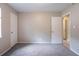 Neutral bedroom with soft gray carpet, a window, and two doors creates a versatile space at 332 Cheryl Ct, Jonesboro, GA 30238