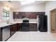 Kitchen featuring a complete black appliance package, light countertops and dark cabinetry at 332 Cheryl Ct, Jonesboro, GA 30238
