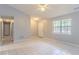 View of a spacious living room showing the front door, large window, and neutral color palette at 332 Cheryl Ct, Jonesboro, GA 30238