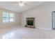 Bright living room featuring a stone fireplace, large window, neutral color palette, and tile flooring at 332 Cheryl Ct, Jonesboro, GA 30238
