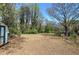 Vast backyard featuring a shed, tall trees, and ample space for outdoor activities at 1122 Byers Sw Dr, Marietta, GA 30060