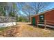 Large backyard with a storage shed, ramp to rear access door on a brick ranch-style house at 1122 Byers Sw Dr, Marietta, GA 30060