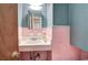 Charming half-bathroom featuring pink tiling, a vanity, and vintage fixtures at 1122 Byers Sw Dr, Marietta, GA 30060