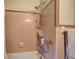 Shower featuring classic tile work and shower head, including convenient grab bar and shower caddy at 1122 Byers Sw Dr, Marietta, GA 30060