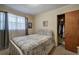 Cozy bedroom with a full-sized bed, closet, and window providing natural light at 1122 Byers Sw Dr, Marietta, GA 30060