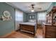 Calming bedroom featuring hardwood floors, two windows and wooden furniture at 1122 Byers Sw Dr, Marietta, GA 30060