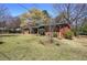 Lush lawn surrounds a single story brick home with covered front porch at 1122 Byers Sw Dr, Marietta, GA 30060