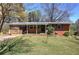 Charming single-story brick home with a covered porch and a well-maintained front yard at 1122 Byers Sw Dr, Marietta, GA 30060