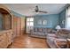 Cozy living room featuring a comfortable couch, ceiling fan, and unique built-in wooden cabinet at 1122 Byers Sw Dr, Marietta, GA 30060