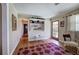 Inviting living room with a hardwood floor and built-in shelving near the entry at 1122 Byers Sw Dr, Marietta, GA 30060