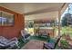 Covered porch offering ample seating with rocking chairs, a table, and backyard views at 1122 Byers Sw Dr, Marietta, GA 30060