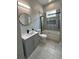 Bathroom features a vanity with modern fixtures and a tiled shower at 135 Yancey Rd, Covington, GA 30014