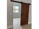 Bedroom features a stylish sliding barn door for a rustic design at 135 Yancey Rd, Covington, GA 30014