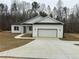 Charming single-story home featuring a white exterior, attached garage, and a well-manicured lawn at 135 Yancey Rd, Covington, GA 30014