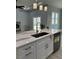Bright kitchen island with modern faucet, stainless steel dishwasher, and pendant lights over the island at 135 Yancey Rd, Covington, GA 30014