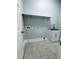 Bright laundry room features tiled floors, storage, and sink at 135 Yancey Rd, Covington, GA 30014
