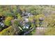 Aerial view of house with mature trees surrounded by green space at 1911 Woodland Hills Nw Ave, Atlanta, GA 30318