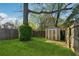 Large backyard with green grass and a shed against a wooden fence at 1911 Woodland Hills Nw Ave, Atlanta, GA 30318