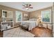 Charming bedroom with wood floors, ceiling fan, and an abundance of natural light at 1911 Woodland Hills Nw Ave, Atlanta, GA 30318