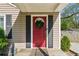 Charming front entrance with a red door, black shutters, a wreath, and well-maintained landscaping at 1911 Woodland Hills Nw Ave, Atlanta, GA 30318