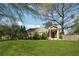 Beautiful home with a vibrant green lawn, complemented by mature trees and landscaping at 1911 Woodland Hills Nw Ave, Atlanta, GA 30318