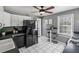 Charming kitchen features white cabinets, black appliances, a ceiling fan, and a cozy breakfast nook near a window at 1911 Woodland Hills Nw Ave, Atlanta, GA 30318