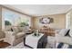 Inviting living room featuring large windows, a comfortable sofa, and a dining area at 1911 Woodland Hills Nw Ave, Atlanta, GA 30318