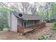 A back deck overlooks the yard from this cozy home at 3841 Greenbrook Dr, Douglasville, GA 30135