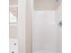 Bright, all-white tiled bathroom with a window at 3841 Greenbrook Dr, Douglasville, GA 30135