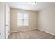 The room has a window with blinds and a carpeted floor; a white door provides a clean contrast at 3841 Greenbrook Dr, Douglasville, GA 30135
