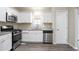 Modern kitchen featuring stainless steel appliances, white cabinetry, and granite countertops at 3841 Greenbrook Dr, Douglasville, GA 30135
