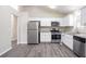 Modern kitchen featuring stainless steel appliances and white cabinetry at 3841 Greenbrook Dr, Douglasville, GA 30135