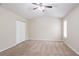 Spacious main bedroom with ceiling fan, carpet flooring, and closet with white bi-fold doors at 3841 Greenbrook Dr, Douglasville, GA 30135