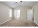 This carpeted main bedroom has a vaulted ceiling, ceiling fan, and includes access to a private bathroom at 3841 Greenbrook Dr, Douglasville, GA 30135