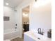 Bathroom featuring a tub-shower with white tile and a light-gray vanity with a modern faucet at 1749 Lauranceae Way, Riverdale, GA 30296