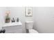 Powder room featuring white vanity with modern black faucet, art and flowers at 1749 Lauranceae Way, Riverdale, GA 30296