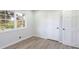 This bright bedroom boasts new flooring, neutral walls, and a large window for natural light at 1749 Lauranceae Way, Riverdale, GA 30296