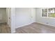 This bedroom features neutral walls, wood floors, a bright window, and ample closet space at 1749 Lauranceae Way, Riverdale, GA 30296