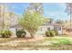 Beautifully landscaped home featuring a white brick facade and mature trees at 1749 Lauranceae Way, Riverdale, GA 30296