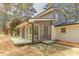 Back of the home showing a sunroom, with painted brick, a deck and landscaping at 1749 Lauranceae Way, Riverdale, GA 30296