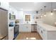 Well-lit kitchen featuring white cabinets, quartz countertops, and stainless appliances at 1749 Lauranceae Way, Riverdale, GA 30296