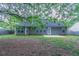 Exterior view of house with a well-kept backyard, featuring green grass and mature trees at 223 Gilliam Ct, Locust Grove, GA 30248