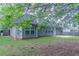 Side view of home's backyard with lush green grass and trees at 223 Gilliam Ct, Locust Grove, GA 30248